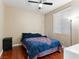 Cozy bedroom with a fan, wood floors, and window letting in natural light at 1309 Rainy Sky Ave, North Las Vegas, NV 89030