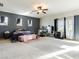 Large bedroom with a ceiling fan, a lot of natural light and neutral carpeting at 1309 Rainy Sky Ave, North Las Vegas, NV 89030
