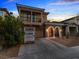 Charming two-story home with a balcony, stone accents, and a well-maintained front yard at 1309 Rainy Sky Ave, North Las Vegas, NV 89030