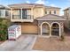 Charming two-story home with a balcony, stone accents, and a well-maintained front yard at 1309 Rainy Sky Ave, North Las Vegas, NV 89030