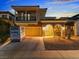 Attractive two-story home featuring a balcony, stone details, and an inviting arched entryway at 1309 Rainy Sky Ave, North Las Vegas, NV 89030