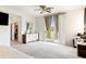 Sun-filled main bedroom features plush carpet, ceiling fan, and balcony at 1309 Rainy Sky Ave, North Las Vegas, NV 89030
