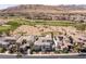 Aerial view of a well-maintained home near a golf course against a mountain backdrop at 2001 Alcova Ridge Dr, Las Vegas, NV 89135