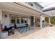 Covered back patio featuring stone columns and comfortable outdoor furniture at 2001 Alcova Ridge Dr, Las Vegas, NV 89135