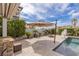 Resort-style backyard with pool, spa, fire pit, built in BBQ, and lush landscaping at 2001 Alcova Ridge Dr, Las Vegas, NV 89135