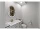 Bright bathroom with white vanity, toilet, and a large framed mirror at 2001 Alcova Ridge Dr, Las Vegas, NV 89135