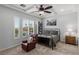 Cozy bedroom with a tray ceiling, a ceiling fan, and plantation shutters at 2001 Alcova Ridge Dr, Las Vegas, NV 89135