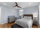 Bright bedroom features hardwood floors, ceiling fan, and natural light from the window at 2001 Alcova Ridge Dr, Las Vegas, NV 89135
