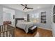 Bright bedroom features hardwood floors, ceiling fan, and natural light from the window at 2001 Alcova Ridge Dr, Las Vegas, NV 89135