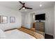 Bright bedroom featuring a ceiling fan, wooden accents, and a mounted TV at 2001 Alcova Ridge Dr, Las Vegas, NV 89135