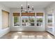 Bright dining area with travertine floors, view of the pool, and stylish chandelier at 2001 Alcova Ridge Dr, Las Vegas, NV 89135