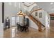Elegant dining area with ornate chandelier and staircase near outdoor patio access at 2001 Alcova Ridge Dr, Las Vegas, NV 89135