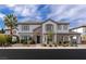 Beautiful two-story home with a well-manicured yard and stone accents at 2001 Alcova Ridge Dr, Las Vegas, NV 89135