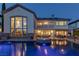 Nighttime view of the home's exterior showcasing the backyard pool, spa, and patio at 2001 Alcova Ridge Dr, Las Vegas, NV 89135