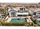 An exterior view shows the backyard with a pool, spa, patio, and lush landscaping at 2001 Alcova Ridge Dr, Las Vegas, NV 89135