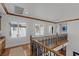 Bright hallway with hardwood floors, elegant banister, and large windows providing beautiful outdoor views at 2001 Alcova Ridge Dr, Las Vegas, NV 89135