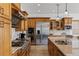 Gourmet kitchen boasts stainless steel appliances, gas range, and custom wood cabinetry at 2001 Alcova Ridge Dr, Las Vegas, NV 89135