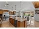Bright and airy kitchen with a central island, stainless steel appliances and backyard views at 2001 Alcova Ridge Dr, Las Vegas, NV 89135