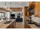 Elegant kitchen open to the living area featuring custom cabinetry and a gas range at 2001 Alcova Ridge Dr, Las Vegas, NV 89135
