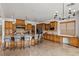 Bright kitchen featuring a central island with bar stools, wood cabinets and modern appliances at 2001 Alcova Ridge Dr, Las Vegas, NV 89135