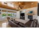 Inviting living room with stone fireplace, wood ceiling and view of the backyard pool at 2001 Alcova Ridge Dr, Las Vegas, NV 89135