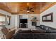 Comfortable living room features stone fireplace and wood paneled ceiling at 2001 Alcova Ridge Dr, Las Vegas, NV 89135