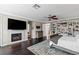 Relaxing main bedroom with hardwood floors, a fireplace, TV, and custom shelving for a luxurious feel at 2001 Alcova Ridge Dr, Las Vegas, NV 89135