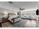 Spacious main bedroom featuring hardwood floors, a sitting area, custom rug, and an abundance of natural light at 2001 Alcova Ridge Dr, Las Vegas, NV 89135