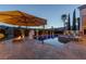A night shot shows a pool area with a fire pit, patio umbrella, spa, and desert landscaping at 2001 Alcova Ridge Dr, Las Vegas, NV 89135