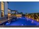 Nighttime shot of the pool highlighting the spa, patio, desert landscaping, and illuminated features at 2001 Alcova Ridge Dr, Las Vegas, NV 89135