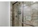 Shower with textured stone-style walls and glass door at 2001 Alcova Ridge Dr, Las Vegas, NV 89135