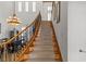 Elegant staircase featuring carpet runner, decorative iron railing, and plenty of natural light in an open floor plan at 2001 Alcova Ridge Dr, Las Vegas, NV 89135