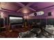 Home theater with dark purple walls, leather seating, and surround sound speakers at 2001 Alcova Ridge Dr, Las Vegas, NV 89135