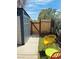 Outdoor storage shed sits in a quaint backyard setting, complete with seating and a wood fence at 228 E Van Wagenen St, Henderson, NV 89015