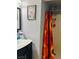 Bathroom showing vanity, mirror, and shower with a retro shower curtain at 228 E Van Wagenen St, Henderson, NV 89015