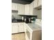 Functional kitchen featuring white cabinets, and stainless steel sink at 228 E Van Wagenen St, Henderson, NV 89015