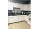 Functional kitchen featuring white cabinets, and stainless steel sink at 228 E Van Wagenen St, Henderson, NV 89015