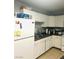 Well-lit kitchen with white cabinets, stainless steel sink, and tile floors at 228 E Van Wagenen St, Henderson, NV 89015