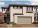 Charming two-story home featuring a neutral color palette, red shutters, and a two-car garage at 2413 Copperbelt St, North Las Vegas, NV 89030
