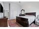 Bright bedroom with a large bed, accent rug, and dresser with mirror at 2419 Country Orchard St, North Las Vegas, NV 89030