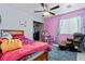 Bedroom with pink walls, colorful decor, and a closet at 2419 Country Orchard St, North Las Vegas, NV 89030