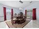 Formal dining room featuring a decorative rug, modern lighting, and sliding glass door to the backyard at 2419 Country Orchard St, North Las Vegas, NV 89030