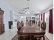 Spacious dining area with adjacent kitchen showcasing bright white cabinets and modern appliances at 2419 Country Orchard St, North Las Vegas, NV 89030