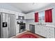 Modern kitchen with white cabinets, stainless steel appliances, and marble floors at 2419 Country Orchard St, North Las Vegas, NV 89030