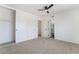 A bright bedroom featuring a closet, ceiling fan, and doorway to the bathroom at 3309 Marionette Ave, Las Vegas, NV 89101