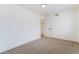 A view of a neutral carpeted bedroom with white walls and trim, well-lit with minimalist features at 3309 Marionette Ave, Las Vegas, NV 89101