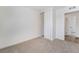 A view of a neutral carpeted bedroom with white walls and trim, and a closet with sliding doors at 3309 Marionette Ave, Las Vegas, NV 89101