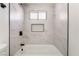 Beautiful tub and shower with a bright white-tiled wall and niche for toiletries at 3309 Marionette Ave, Las Vegas, NV 89101