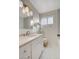 Bright bathroom featuring hexagon tile floors, updated lighting, and a modern vanity at 3821 1/2 Daisy St # 25, Las Vegas, NV 89119