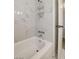 Bright bathtub and shower with sleek chrome fixtures and marble-style tiling at 3821 1/2 Daisy St # 25, Las Vegas, NV 89119
